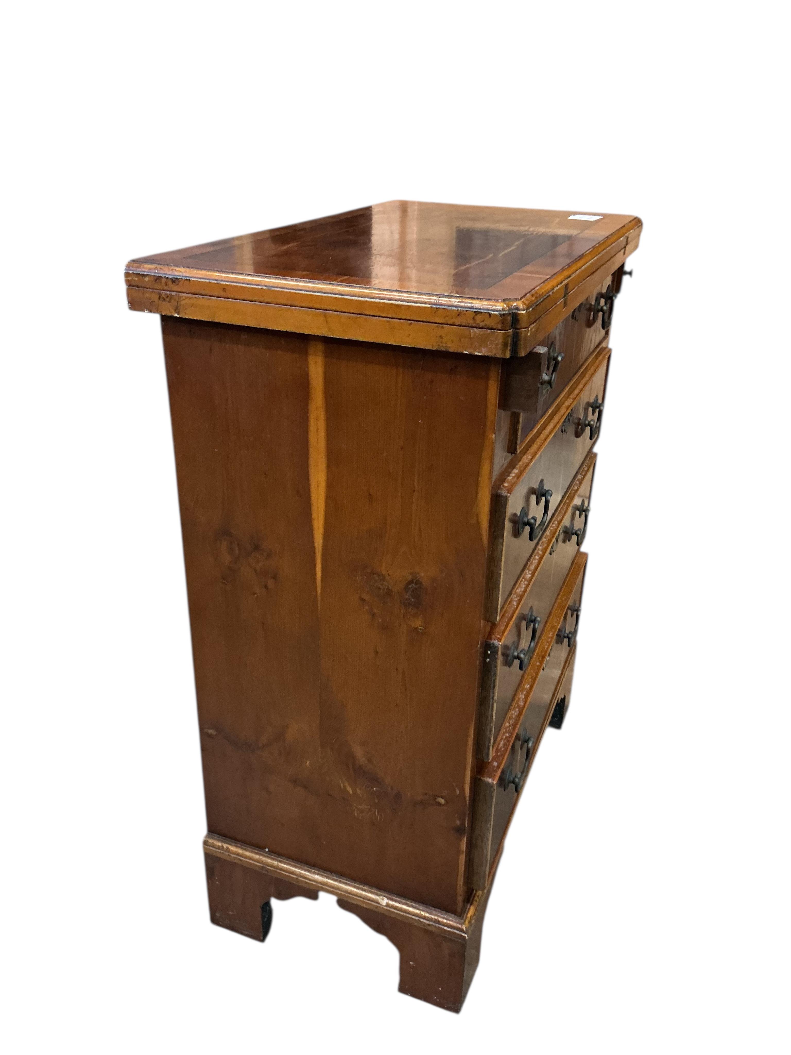 A small reproduction yew bachelor's chest, width 59cm, depth 34cm, height 76cm